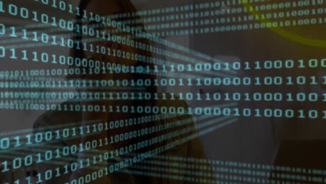 In school, person working on computer with binary code animation overlaying screen