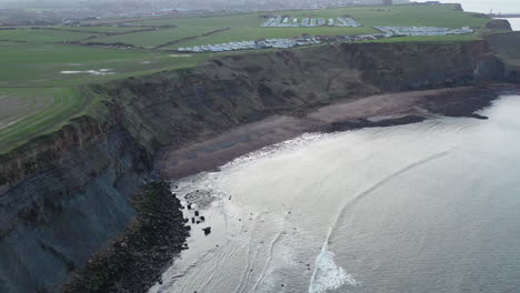 aerial footage moving forward along the coast at saltwick bay heading towards whitby, yorkshire, uk