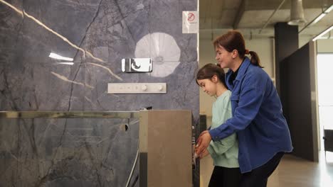 mother and daughter in a modern bathroom showroom