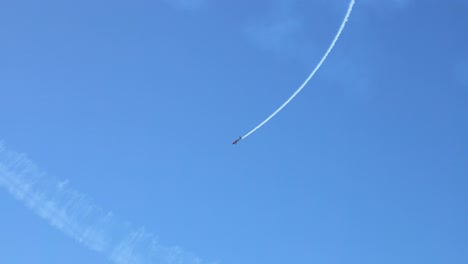 airplane creating smoke trails in the sky