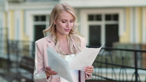 close up view of woman reading documents on the street