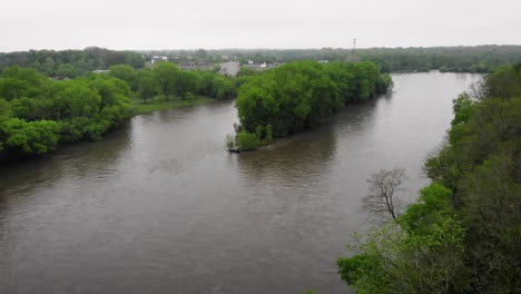 A drone shot of a midwest river on a gloomy day
