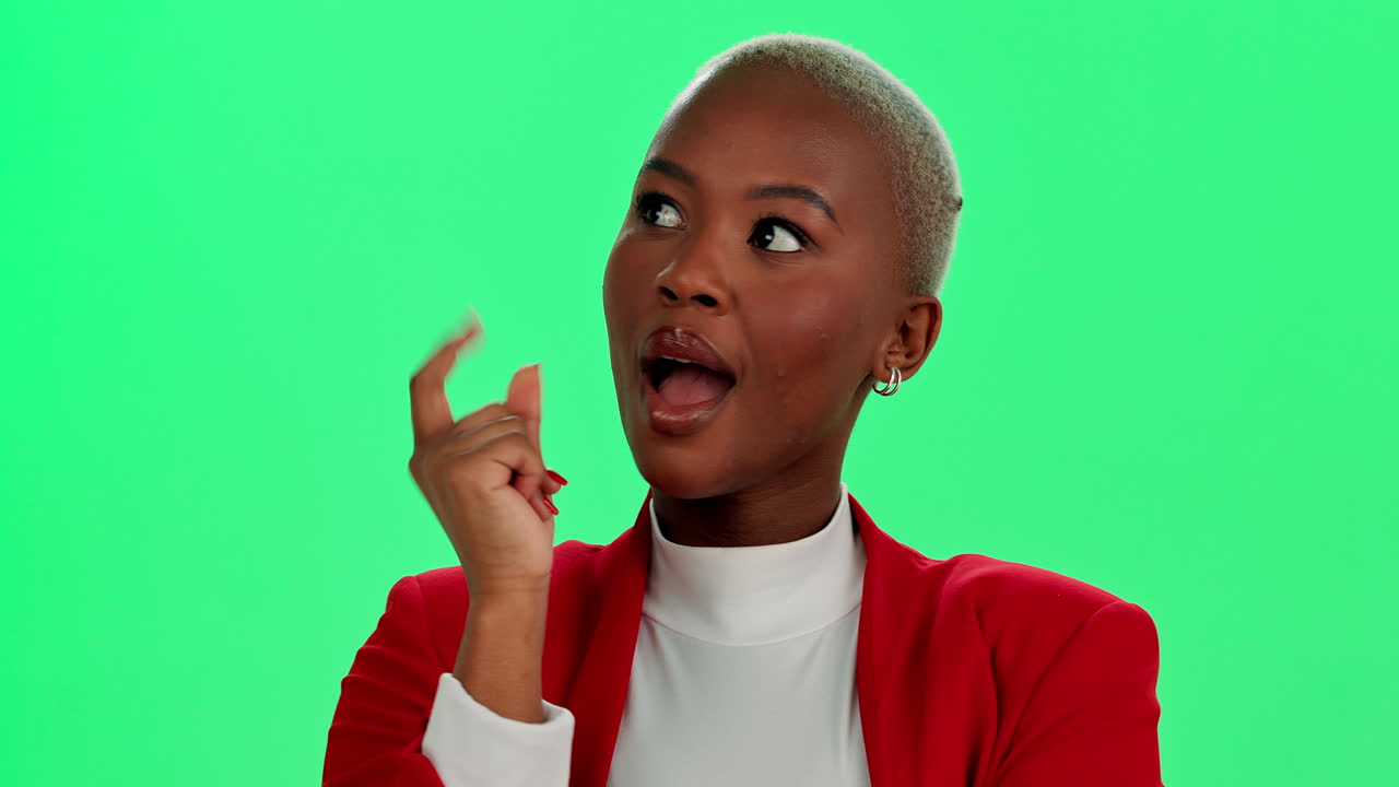 Woman in red blazer pointing up on green screen