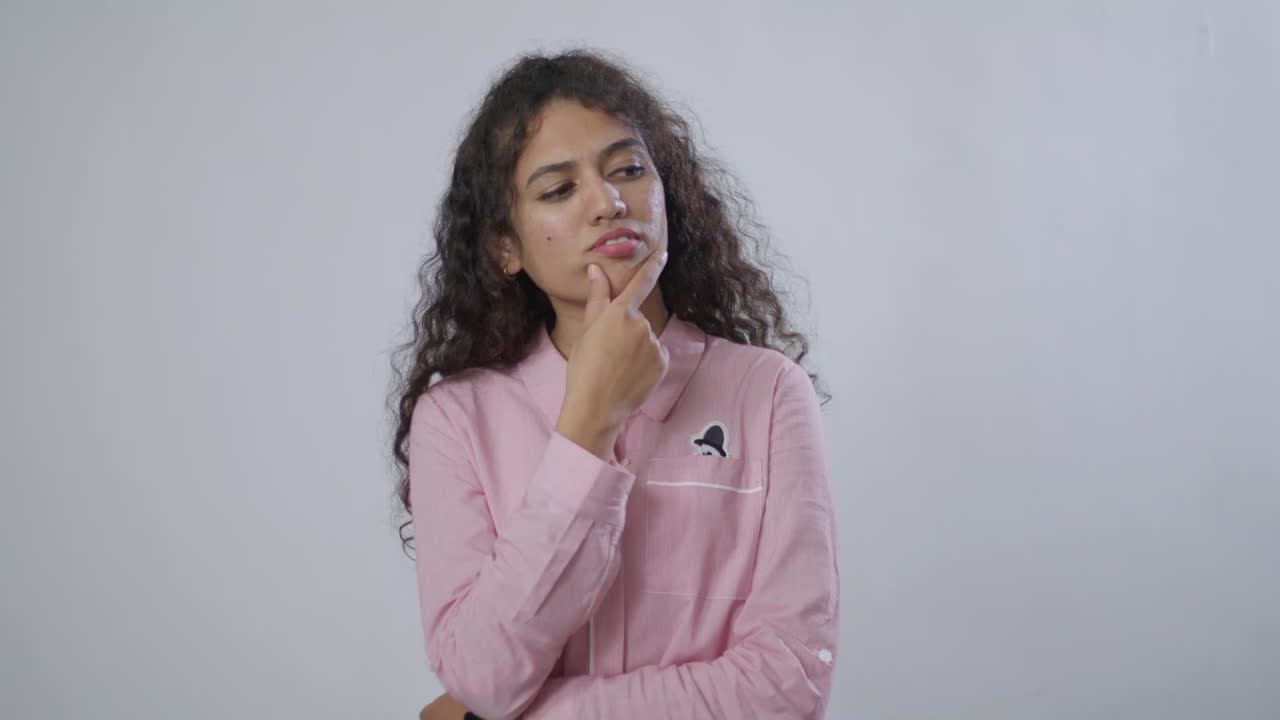 Woman with curly hair thinking