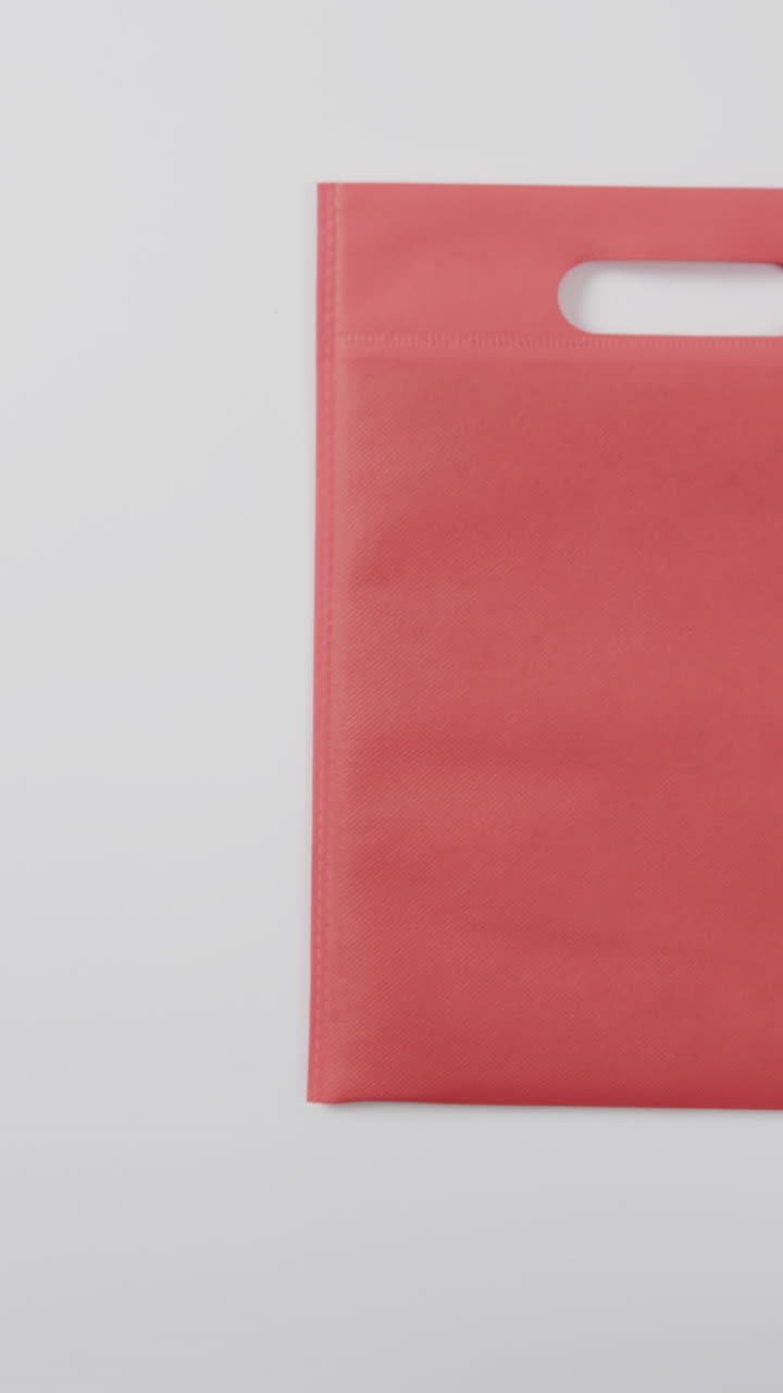 Vertical video of red bag and copy space on white background