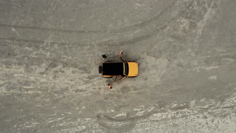 group of travellers step out of suv for exploration in desert,aerial