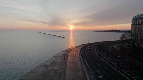 Aerial-view-traffic-on-the-Lake-Shore-Drive-and-people-on-the-Lakefront-Trail,-sunny-morning-in-Chicago,-USA---descending,-drone-shot