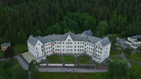 drone push-in toward haunted luster sanatorium historic mental hospital, norway