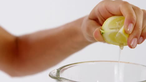 hand of woman squeezing sweet lime in blender