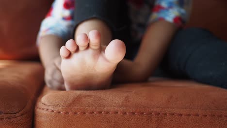 child's feet on a couch