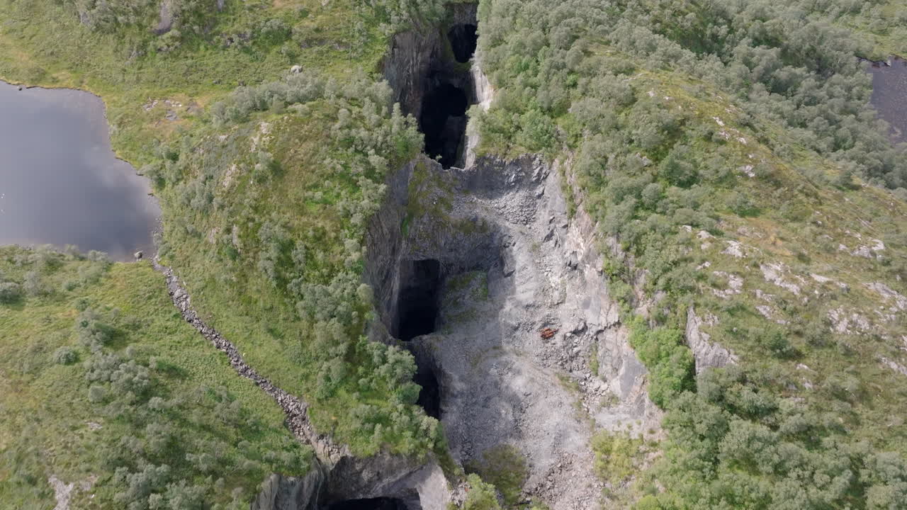 Cinematic aerial shot of old lime mines in Norway’s highlands, featuring rocky terrain, cliffs, and relics of abandoned industry
