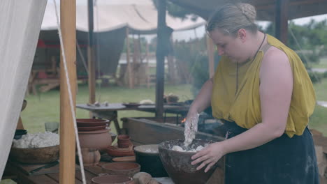 medieval woman preparing dough