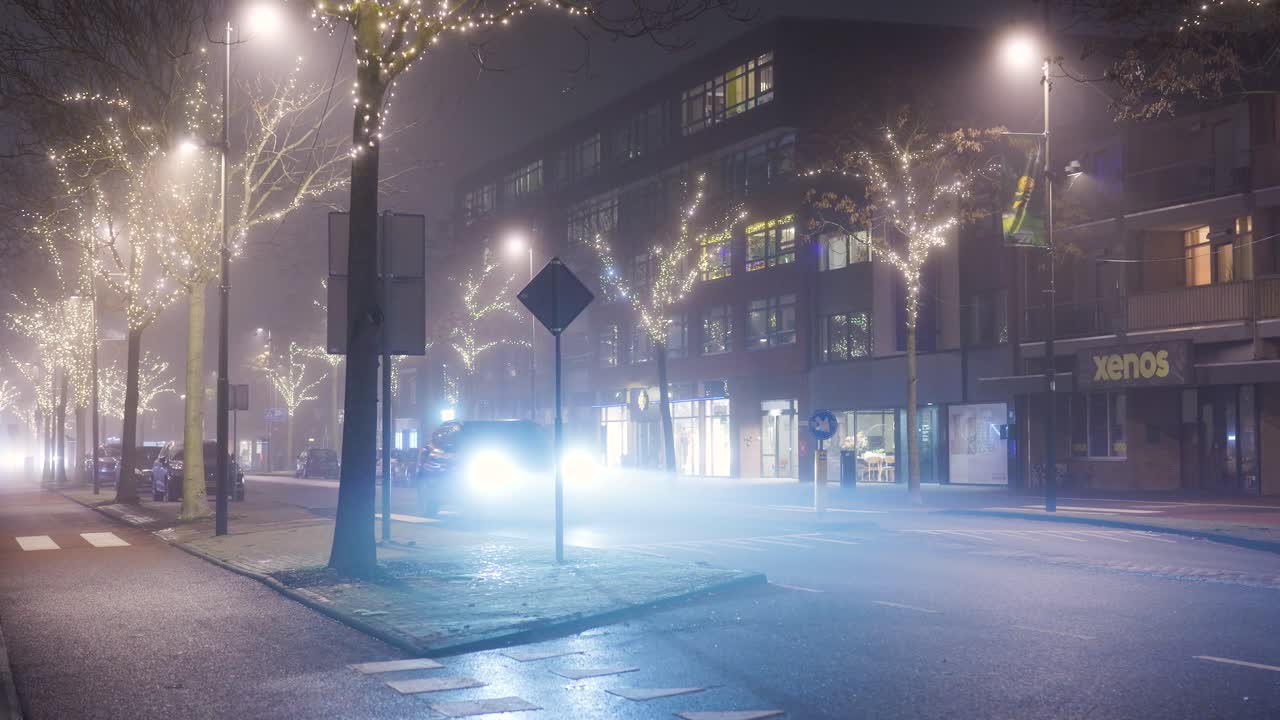 City street at night with fog and decorated trees