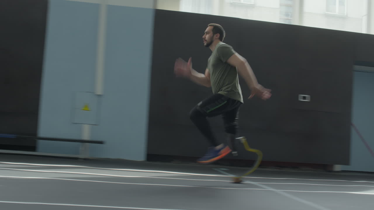 Athlete with Below Knee Prosthesis Running in Stadium
