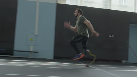 athlete with below knee prosthesis running in stadium