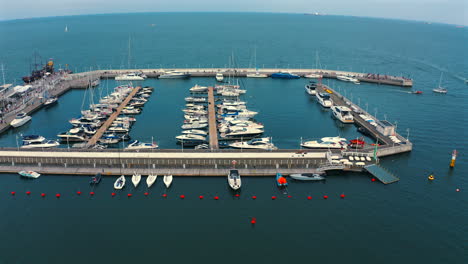 Drone-flying-above-marina-on-baltic-sea-in-Sopot,-Poland-at-sunny-day-with-yachts