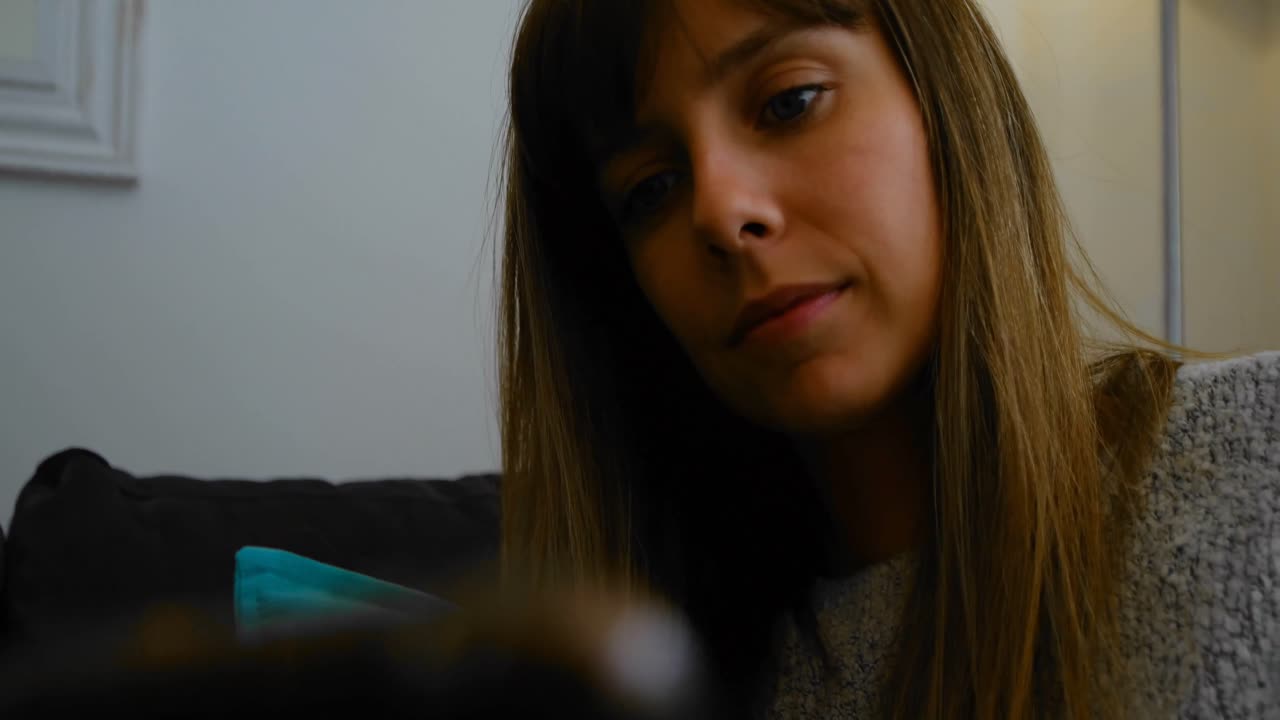 Woman using digital tablet on sofa 4k