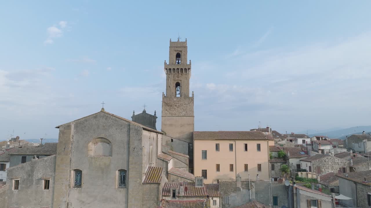 Aerial Drone view of the hilltop Medieval town of Pitigliano, Tuscany and the Valdorcia in morning light, flying over old buildings and rooftops, in 4K