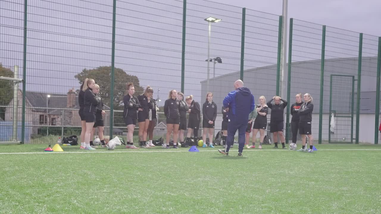 Coaching soccer session, players, manager group outdoors meeting