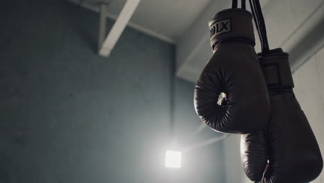 hanging boxing gloves in a gym