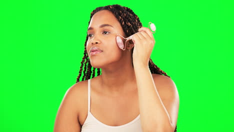 woman, face roller and skincare on green screen