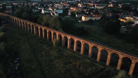 Drone-footage-of-the-Aqueduct-of-Nottolini,-Lucca,-in-the-region-of-Tuscany,-Italy-during-sunrise-in-4K