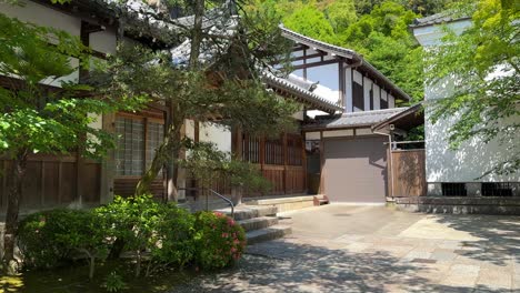 japanese wooden building with vegetation and trees around