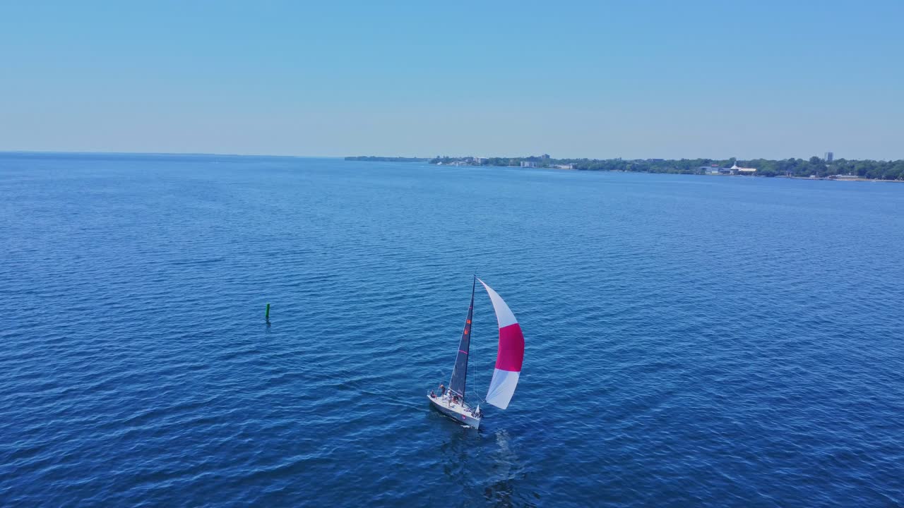 pequeño velero aéreo en aguas abiertas en un día de cielo azul