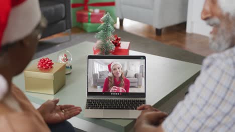 Feliz-Pareja-Afroamericana-De-Edad-Avanzada-En-Videollamada-En-Una-Computadora-Portátil-Con-Una-Amiga-En-Navidad