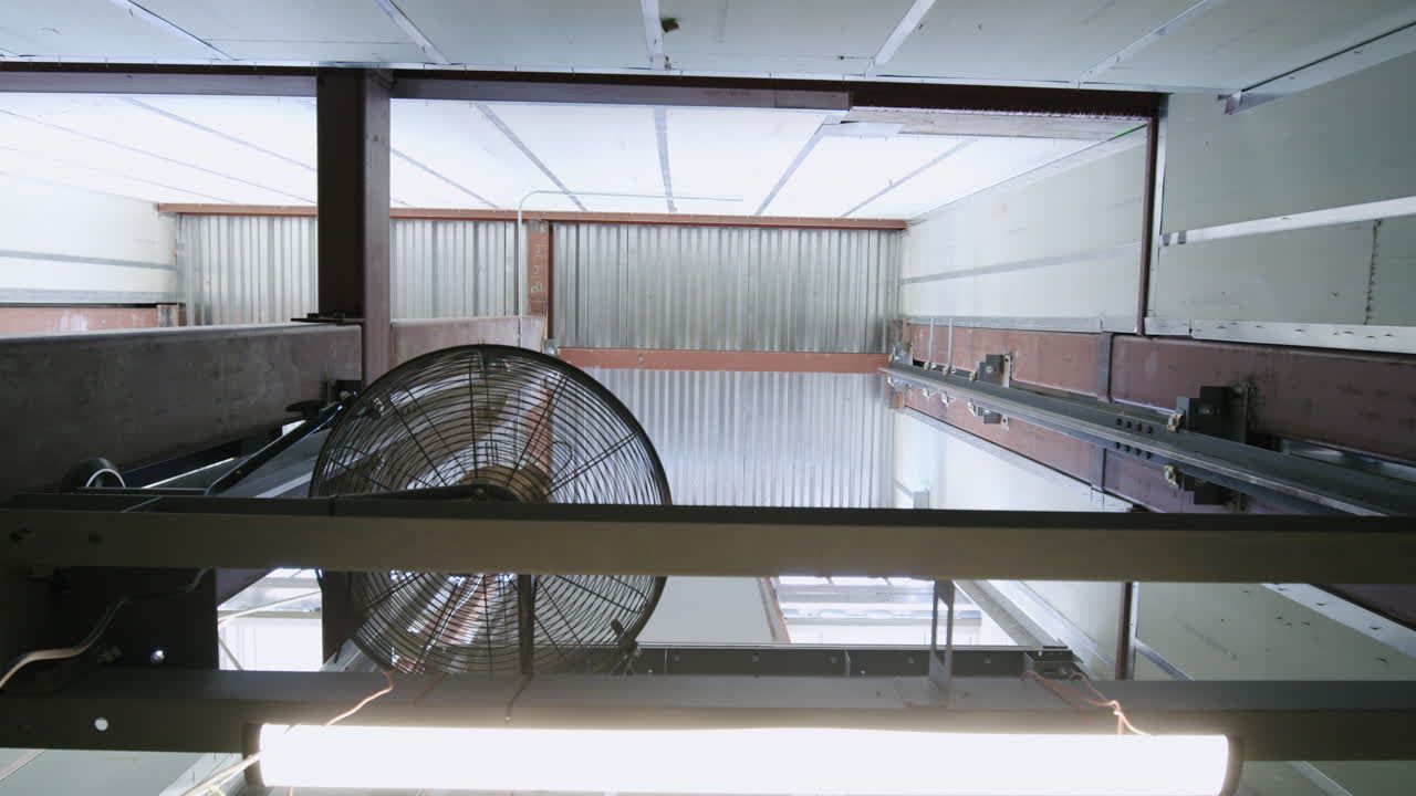 Industrial Fan and Steel Beams in a Warehouse Interior