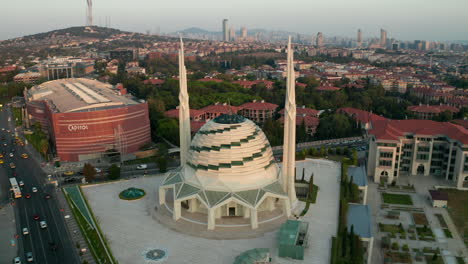 Futuristic-Mosque-in-Istanbul,-Modern-looking-Temple-at-Sunset-with-Cityscape,-Aerial-forward