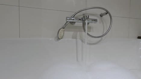 filling the bathtub with the tap.