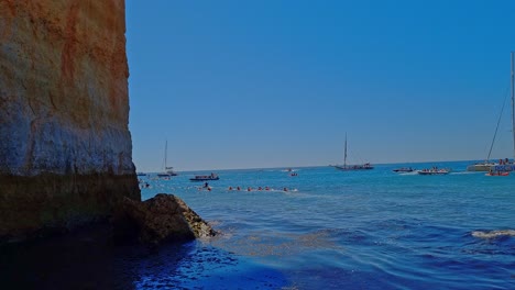 Static-shot-Of-Tourists-Boats-Sailing-In-Stunning-Blue-Sea-Scape,-Benagil,-Portugal