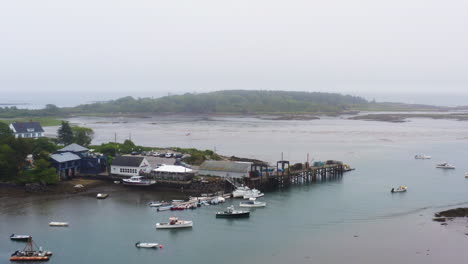 amazing drone shot of marina on coast with lobster fishing boats and commercial pier hd 30p