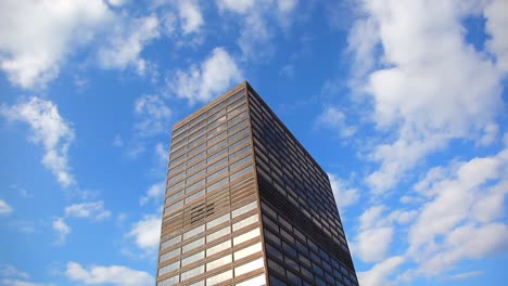 Looking up at a tall building in the clouds that could be kingpins hide out or a highly respectable Office