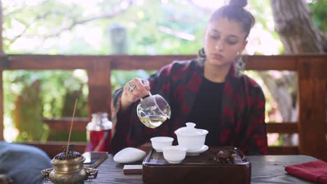 woman pouring tea in a traditional setting