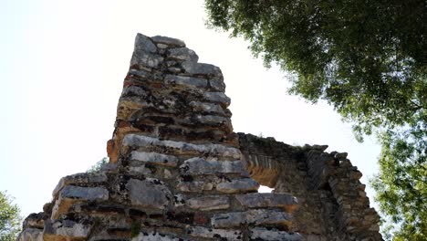 Butrint,-Albania,-rays-of-summer-sun-illuminating-the-stone-ruins-of-ancient-buildings