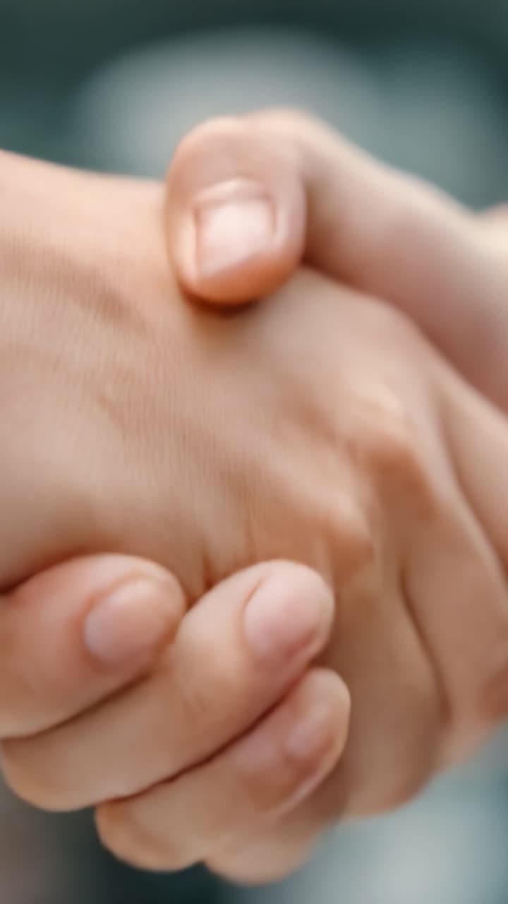 A Close-Up of Two Hands Engaged in a Symbolic Gesture of Unity, Connection, or Agreement, Capturing the Essence of Trust and Collaboration