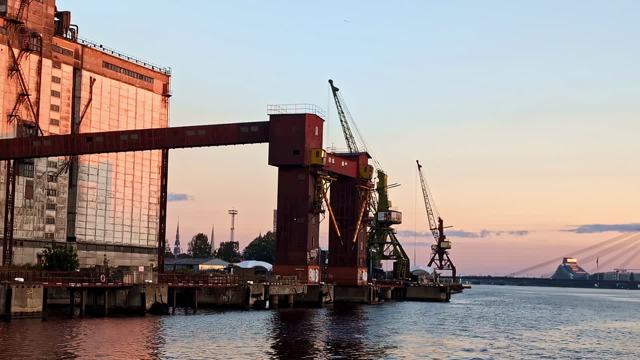 Sunset over an Industrial Port with Rusty Cranes