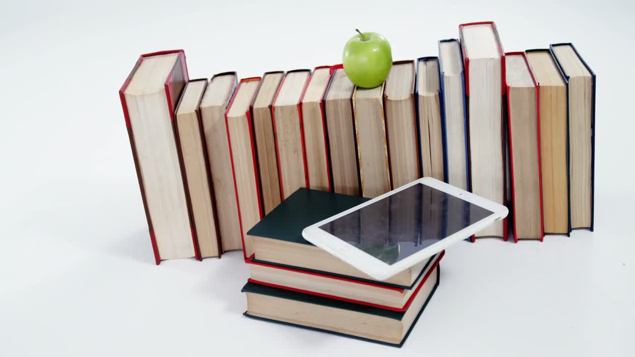 Apple, digital tablet and books on white background