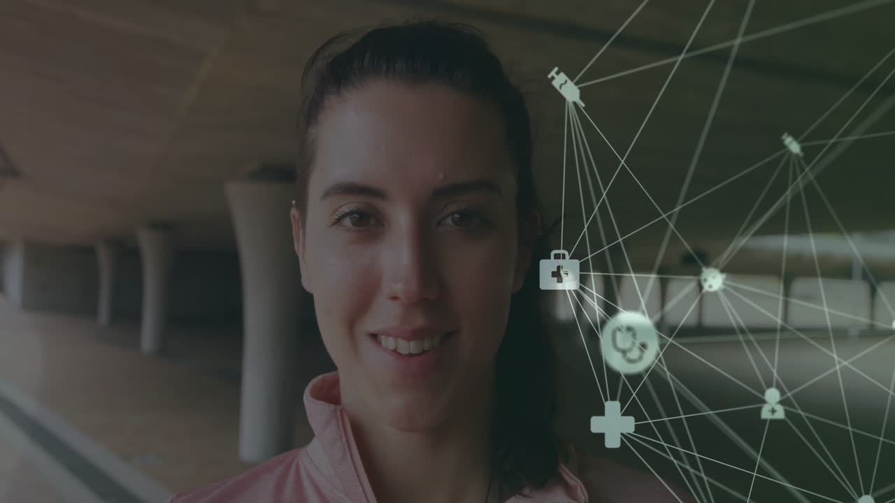 Woman standing facing camera in corridor health network appearing right nodes moving bringing smile