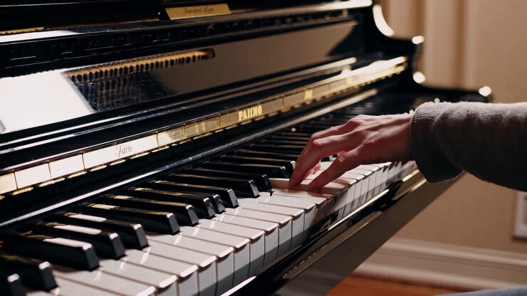 Close-up video of a pianist's hand playing a grand piano, showcasing the elegance and detail