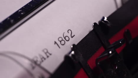 year 1862, typing on vintage typewriter and white paper, macro close up