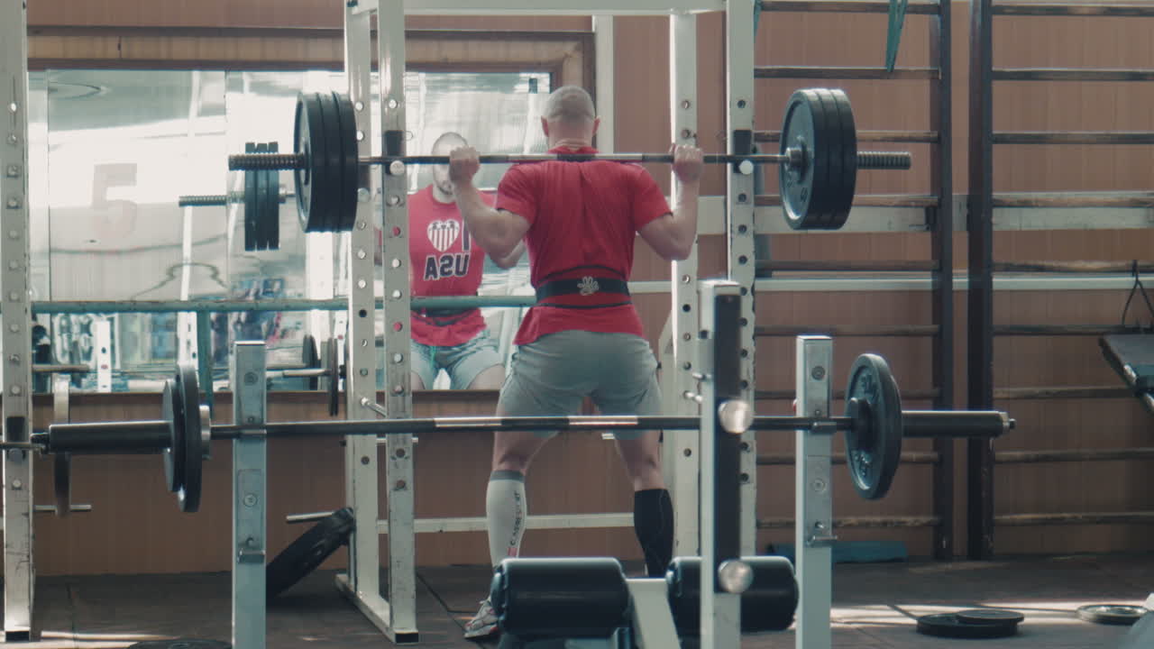 Man Weightlifting Squat in Gym