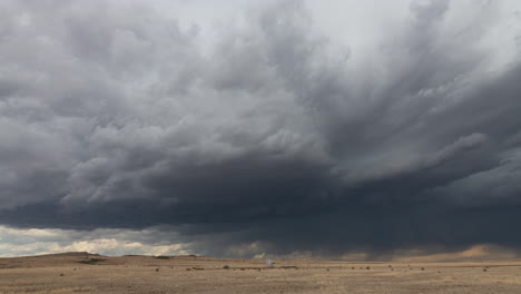 two bulls fight as a supercell forms in the foothills of the new mexico mountains