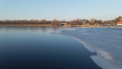 lake completely frozen without snow reflections on the ice aerial view