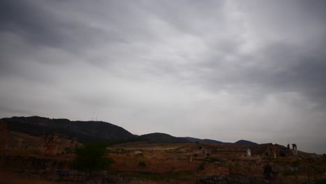 Panning-from-grey-skies-to-burned-brown-grass-at-ancient-roman-Hierapolis-site-in-Denzil-Turkey