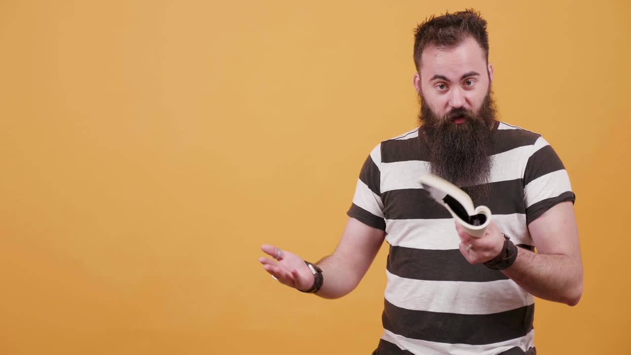 Man with beard reading a book