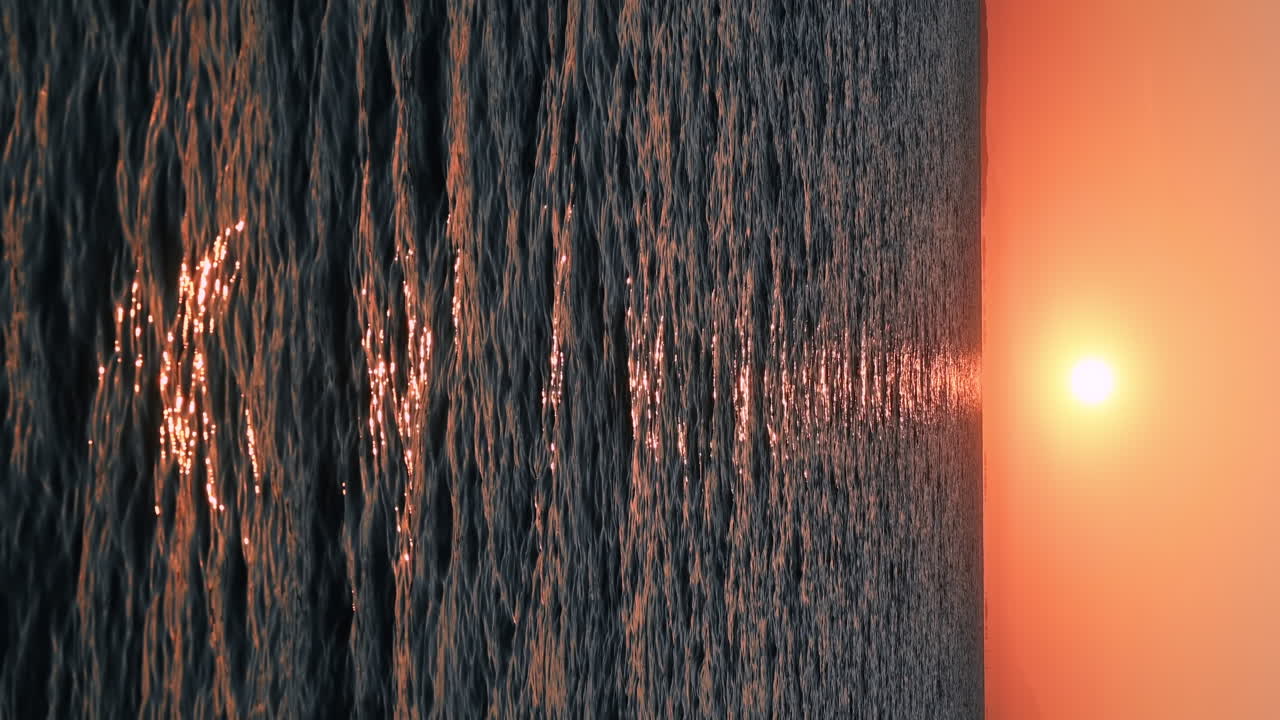 Sunset on the Aegean sea. Bright Sun, land in the distance, water, Greece. Vertical video