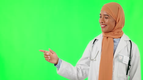 Muslim-woman,-doctor-and-pointing-on-green-screen